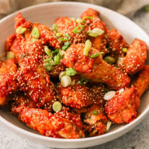 a bowl of air fryer korean fried chicken wings.