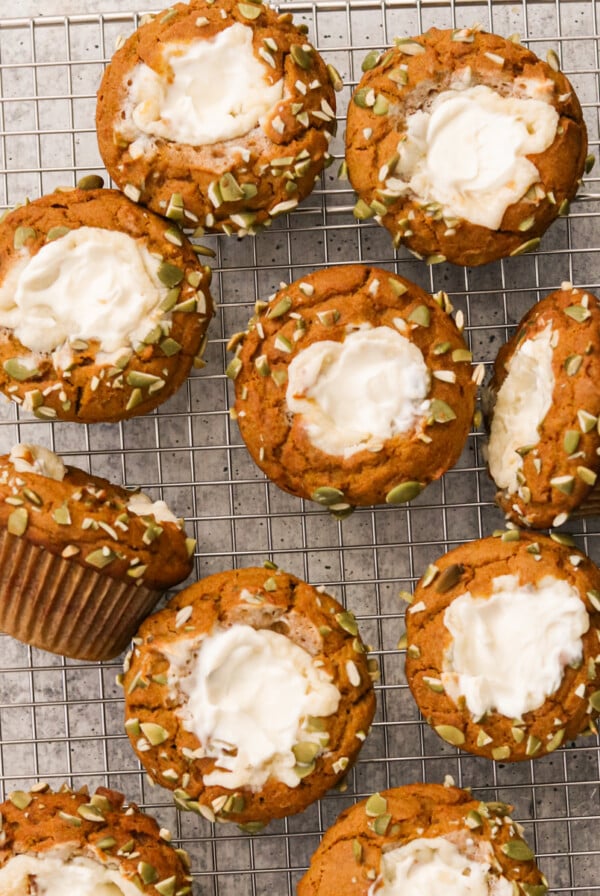 pumpkin cream cheese muffins on a metal cooking rack