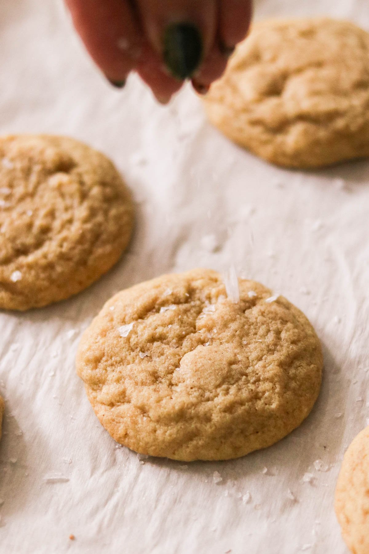 sprinkling flakey sea salt onto the tops of the chipless cookies