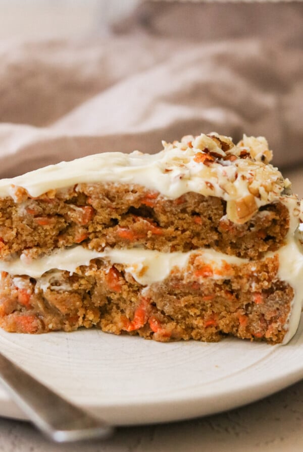 a slice of gluten free carrot cake on a white plate