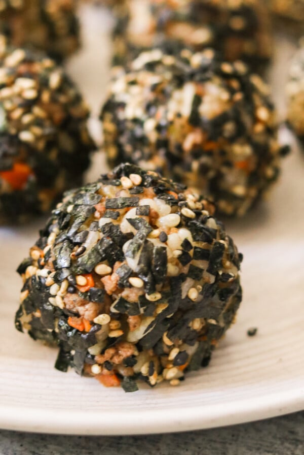 an up close shot of korean rice balls on a white plate