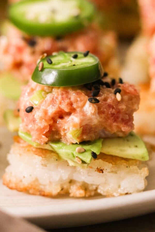 spicy tuna crispy rice bite topped with jalapeno and sesame seeds