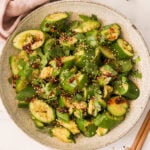 a smashed cucumber salad in a serving bowl