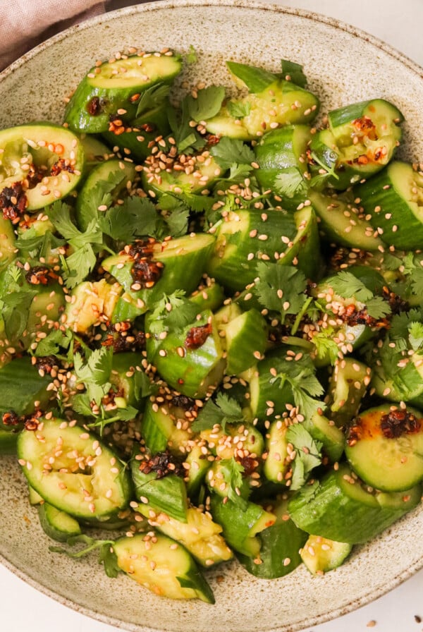 a smashed cucumber salad in a serving bowl