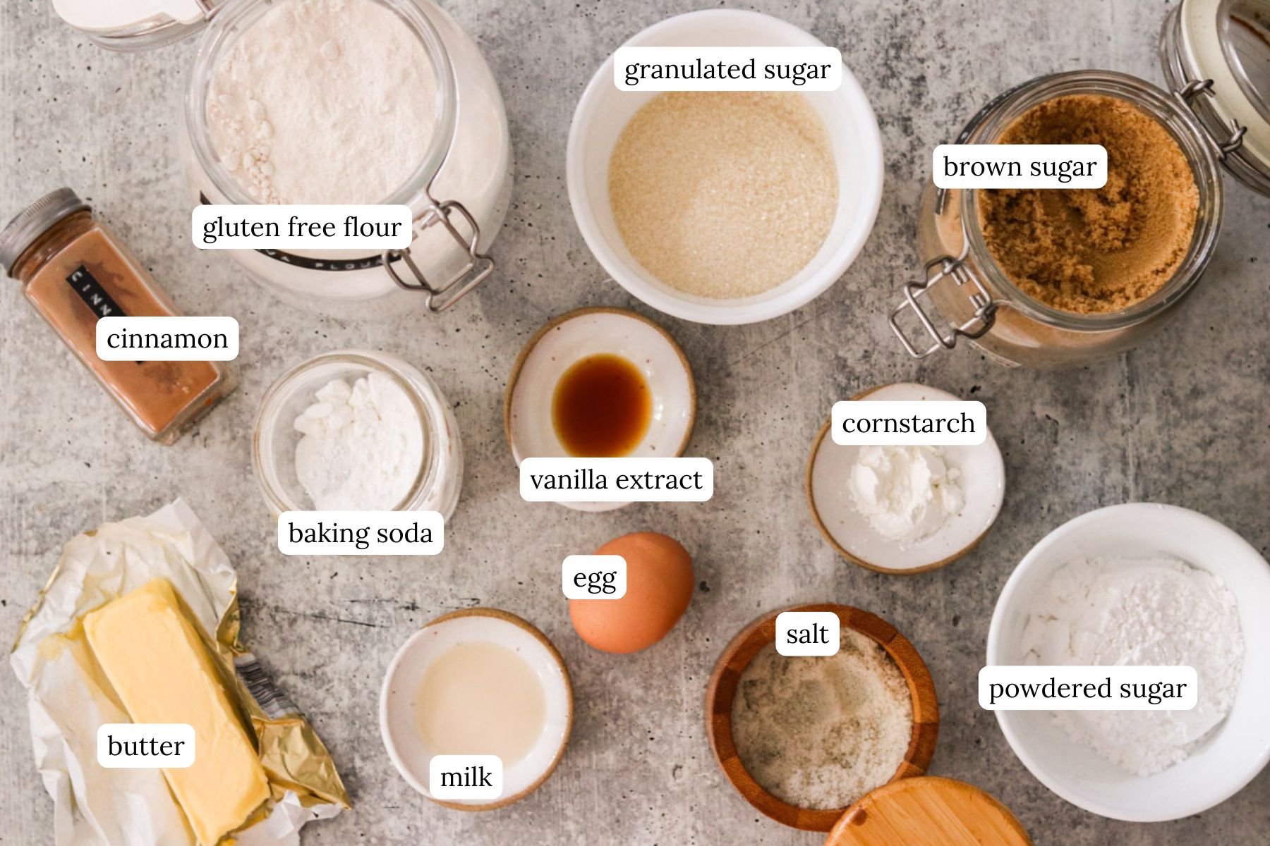 Ingredients for gluten free cinnamon roll cookies on a countertop labeled.