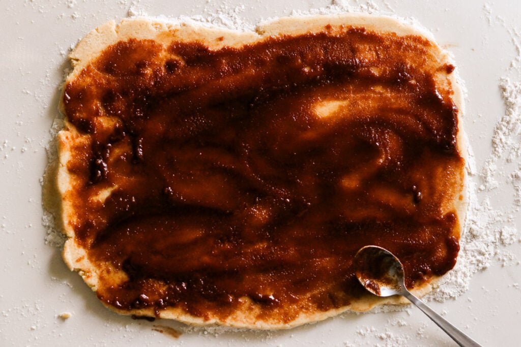 Adding cinnamon sugar filling on top of the dough