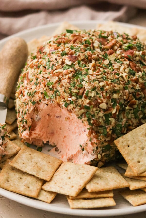 smoked salmon cheese ball on a plate with crackers