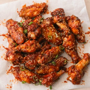 gochujang chicken wings on a white sheet of parchment paper