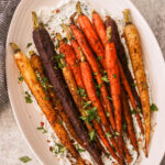 colorful moroccan spiced carrots on a white serving platter