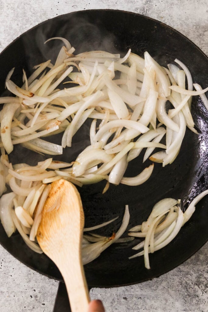 sauteeing onions in a cast iron pan 