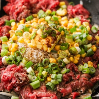 beef pepper rice cooking in a cast iron pan