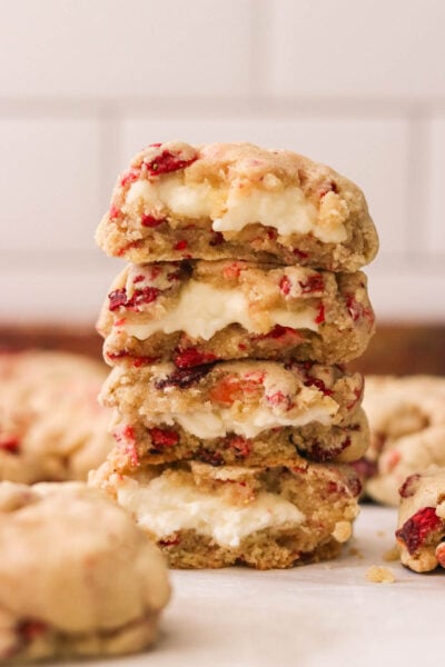 four strawberry cheesecake cookies stacked on top of each other