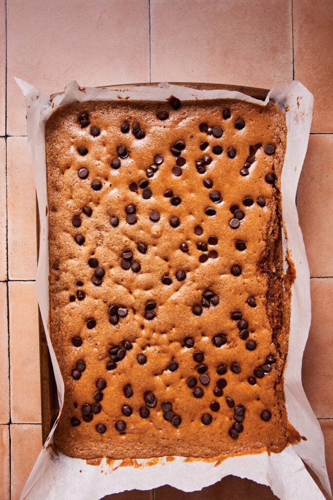 Blondies baking in the oven with chocolate chips on top