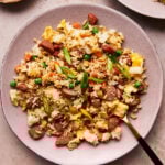 hot dog fried rice on a plate with a fork