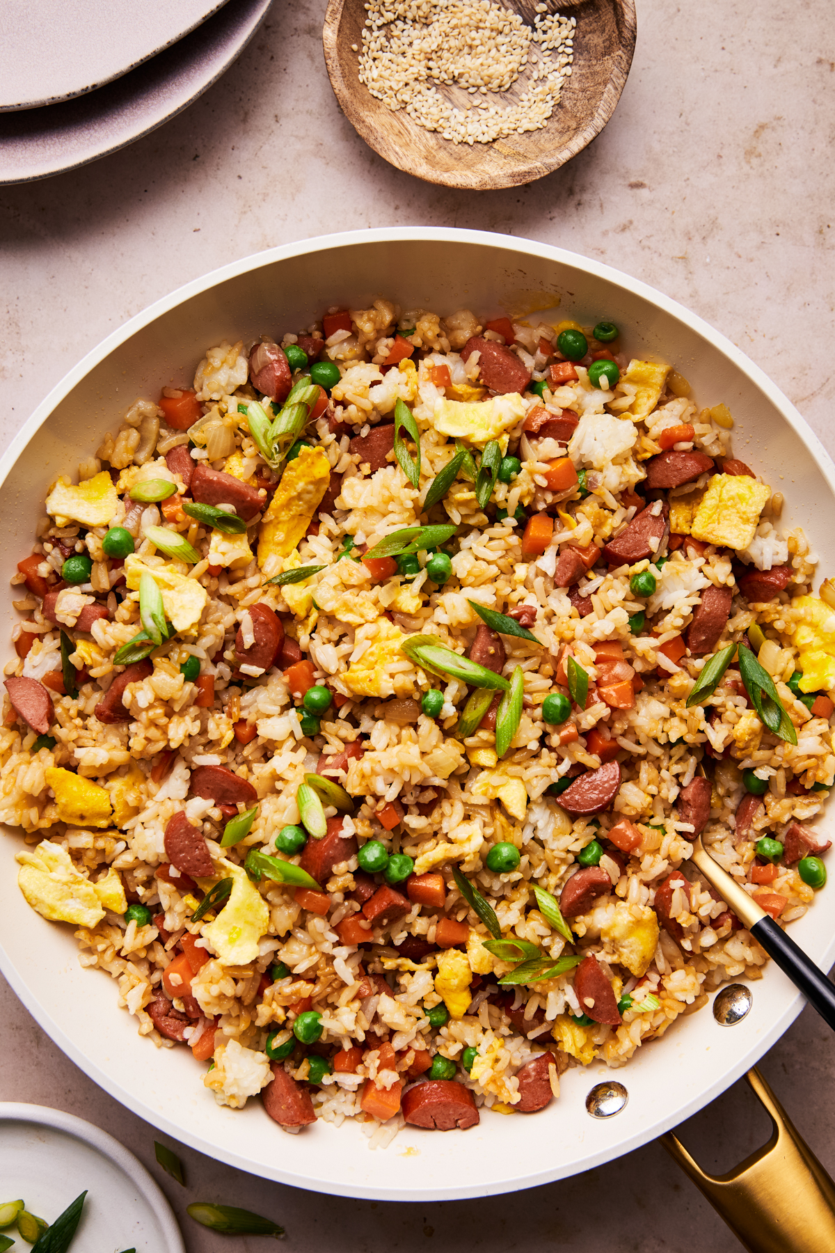 hot dog fried rice on a plate with a serving spoon