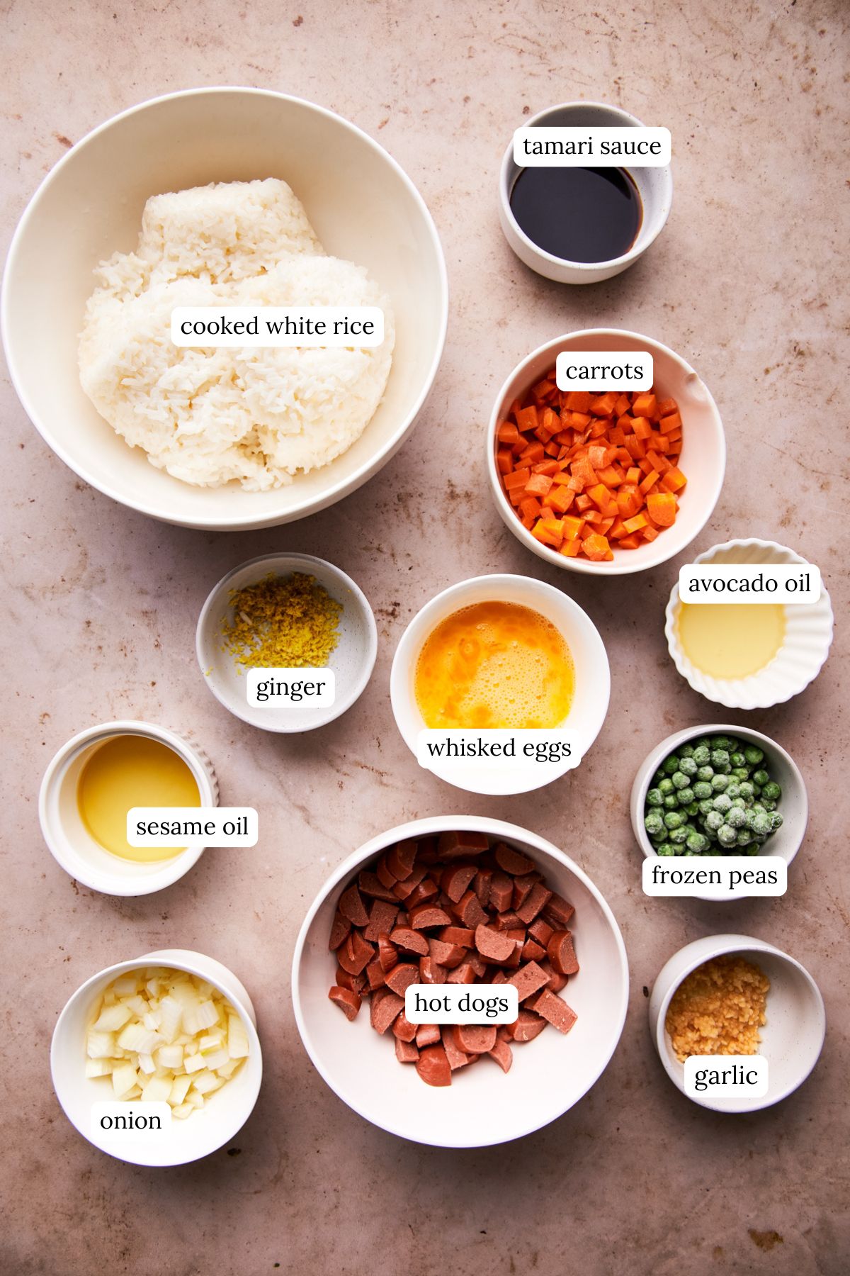 ingredients for hot dog fried rice including white rice, hot dogs, and veggies