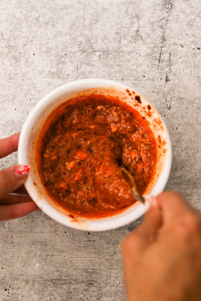 Mixing the bang bang sauce in a small bowl
