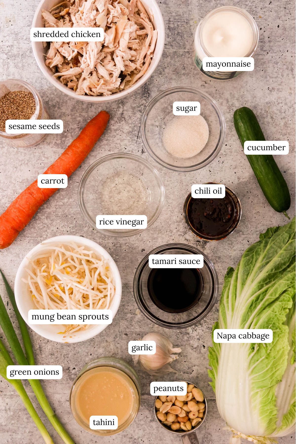 Raw ingredients for bang bang chicken salad arranged on a surface