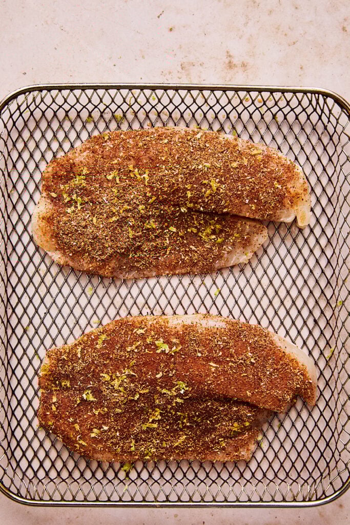 tilapia cooking in an air fryer
