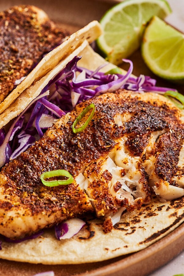 a piece of air fry tilapia atop a tortilla