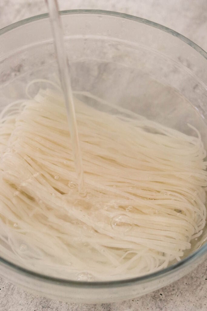 Soaked rice noodles drained and rinsed in a colander