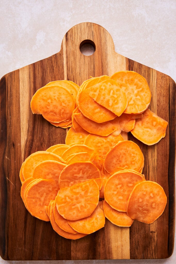 sliced sweet potatoes on a cutting board