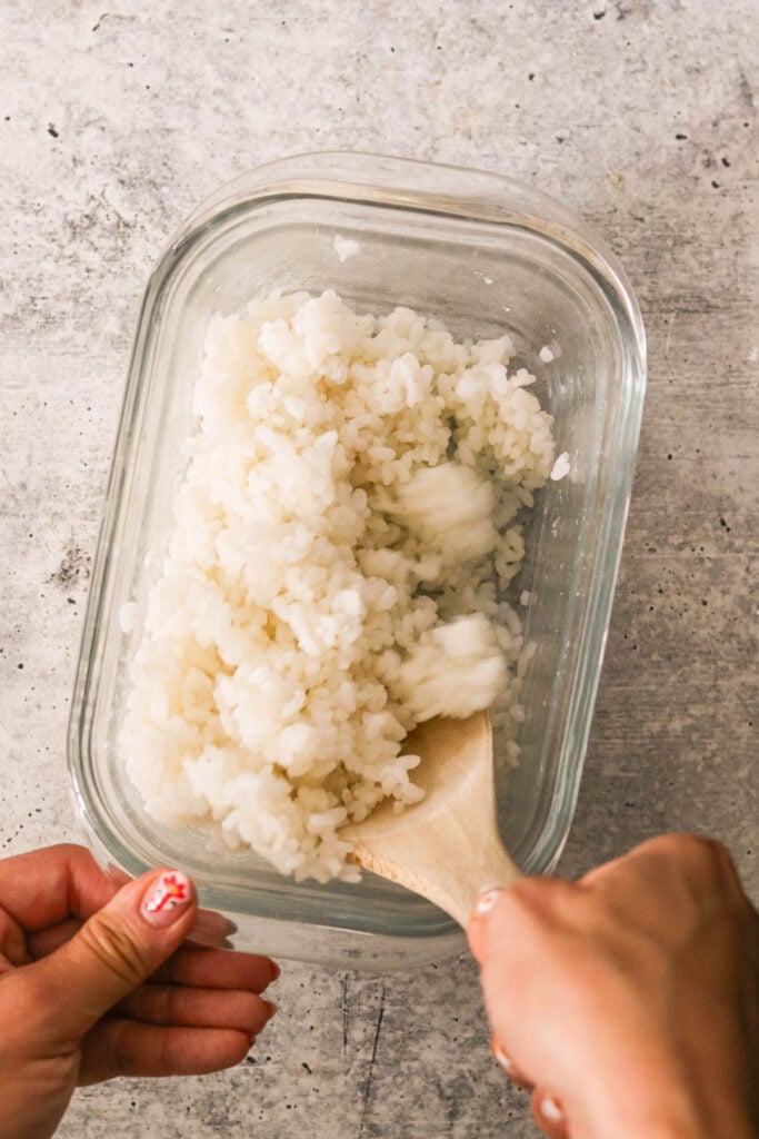 sushi rice mixed with vinegar, sugar, and salt in a white bowl