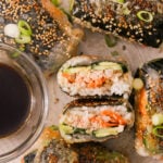 crispy rice paper sushi rolls served with soy sauce on a plate