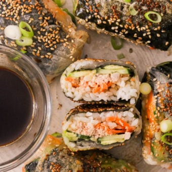 crispy rice paper sushi rolls served with soy sauce on a plate
