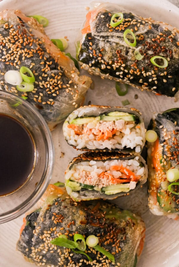crispy rice paper sushi rolls served with soy sauce on a plate