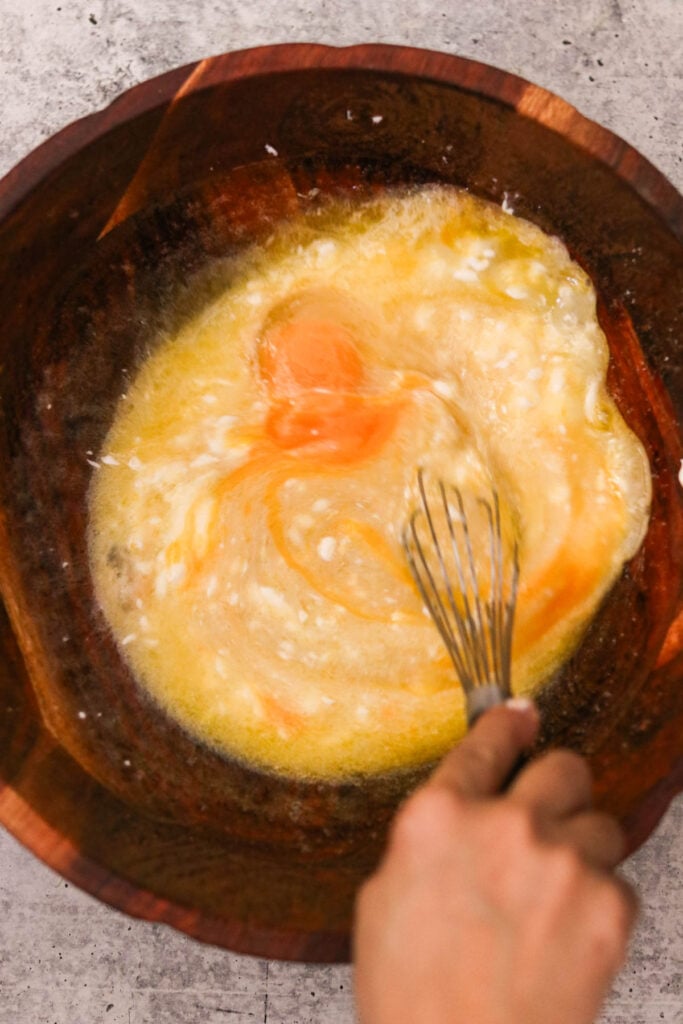Wet ingredients including yogurt, eggs, and lemon juice whisked together

