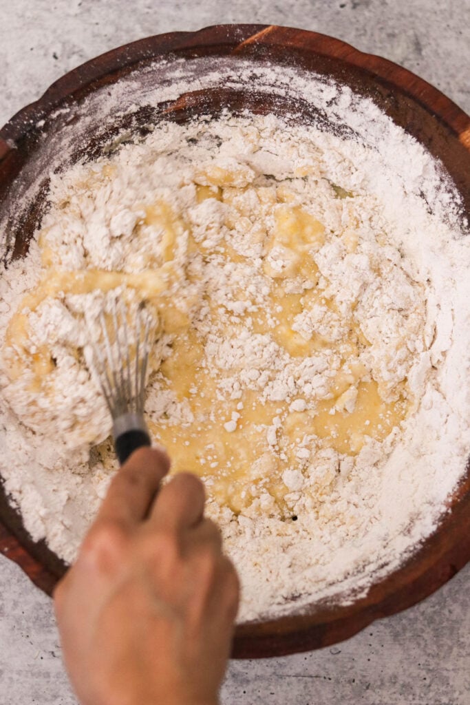 Dry ingredients stirred into wet ingredients to form muffin batter

