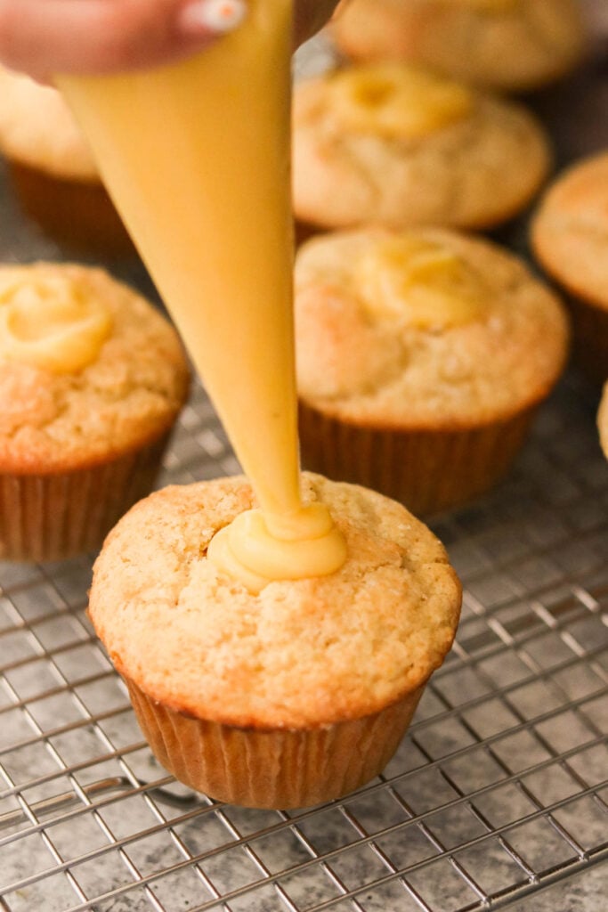 Muffin filled with lemon curd using a piping bag for precision

