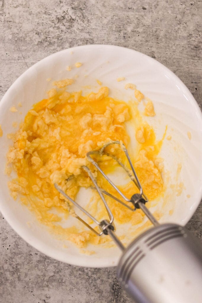 Whisking eggs and lemon juice into the sugar mixture for homemade lemon curd

