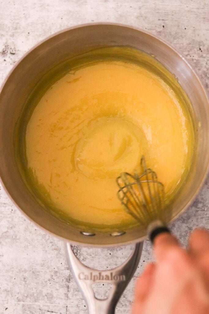 Lemon curd thickening on the stovetop in a small saucepan

