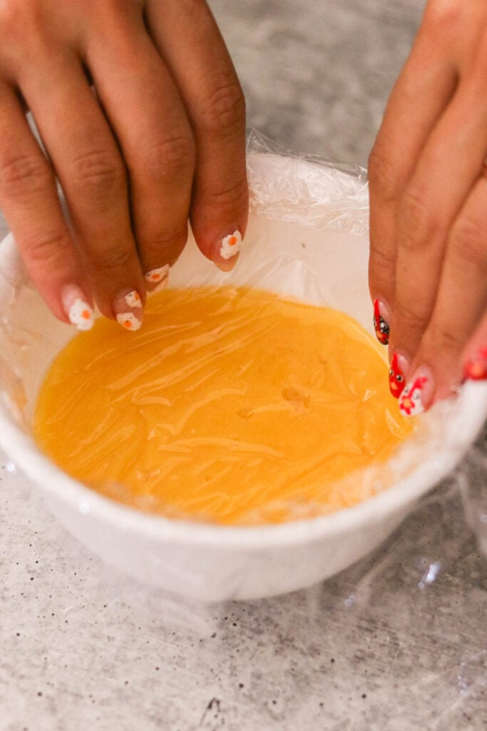 Finished lemon curd chilling with plastic wrap on top to prevent skin

