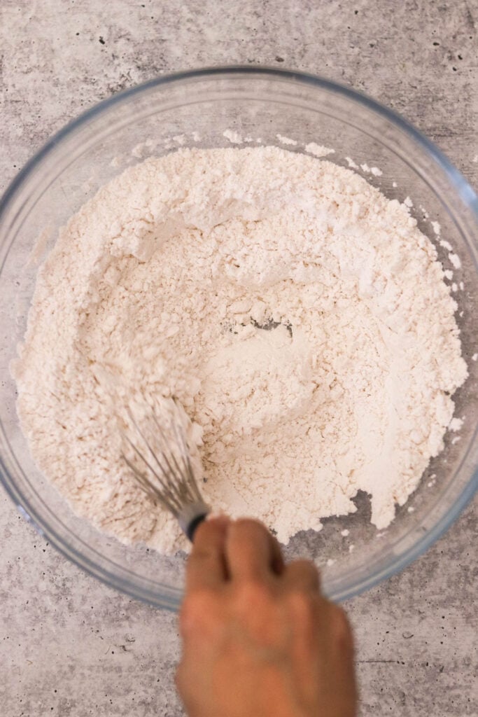 Dry ingredients for muffins combined in a mixing bowl with a whisk
