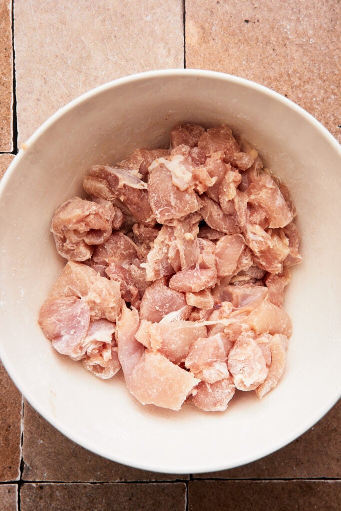 chicken cut into bite sized pieces and tossed with starch in a large mixing bowl 
