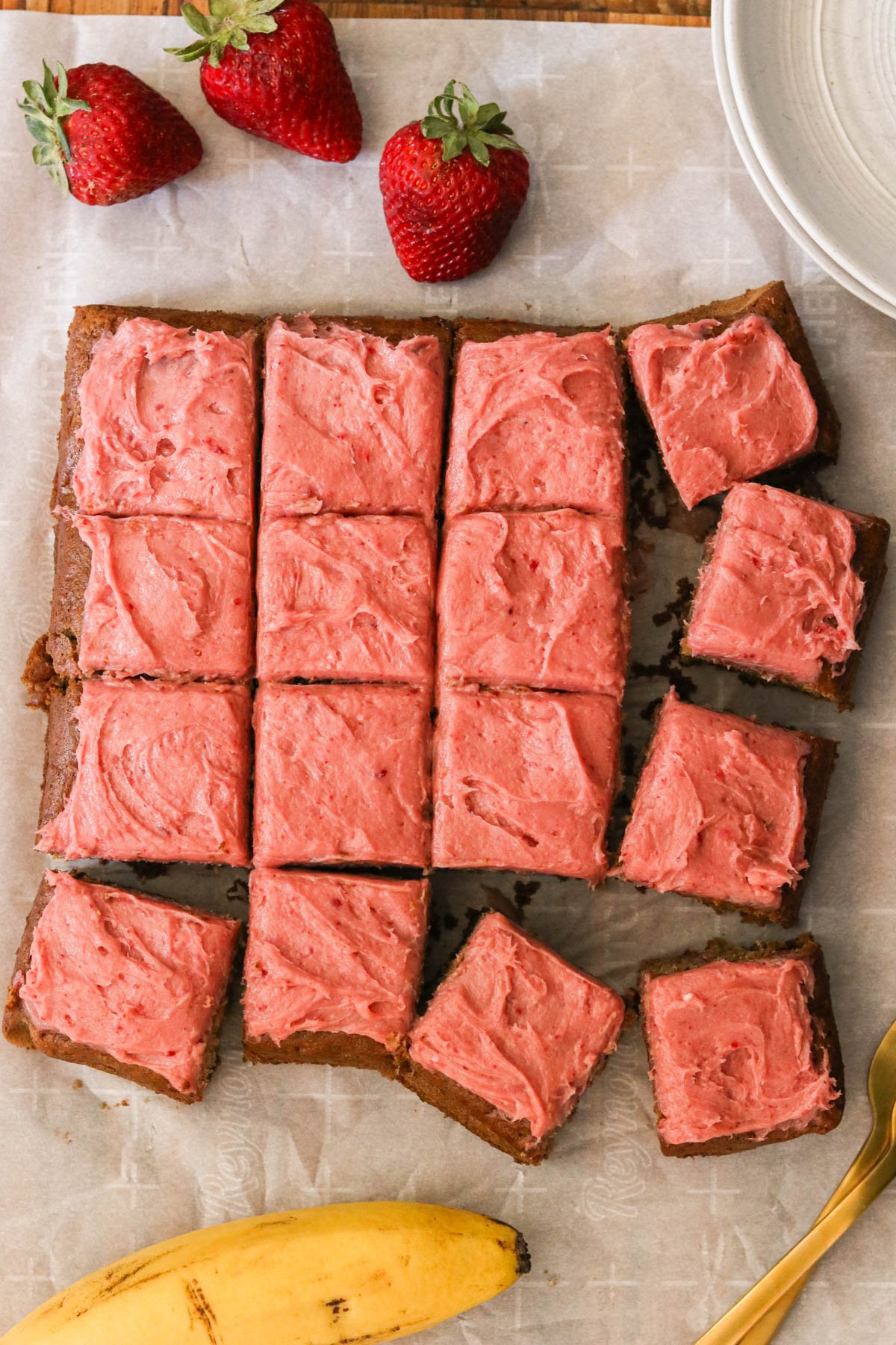 cake squares topped with strawberry cream cheese frosting. 