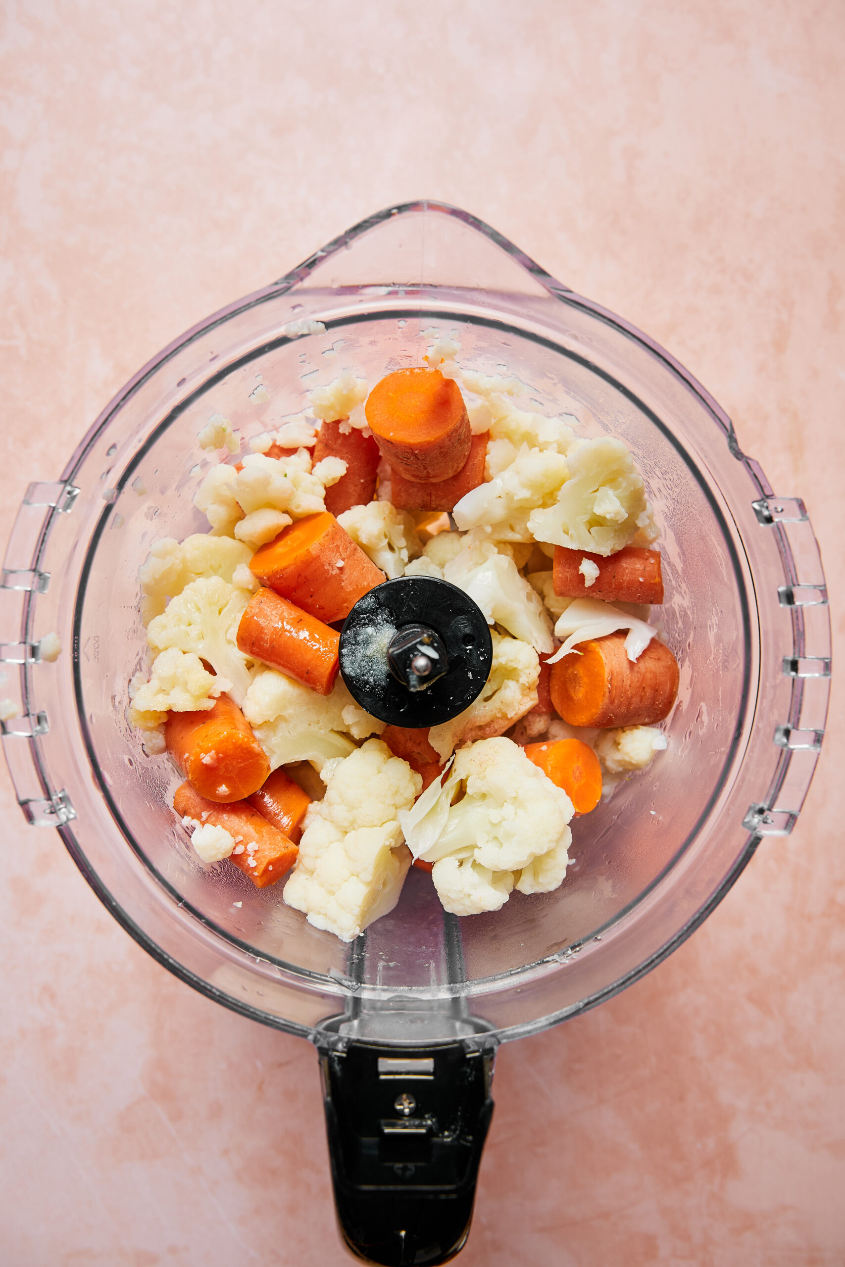 Cooked cauliflower and carrots ready to be blended in a food processor with ghee and salt for mash topping.