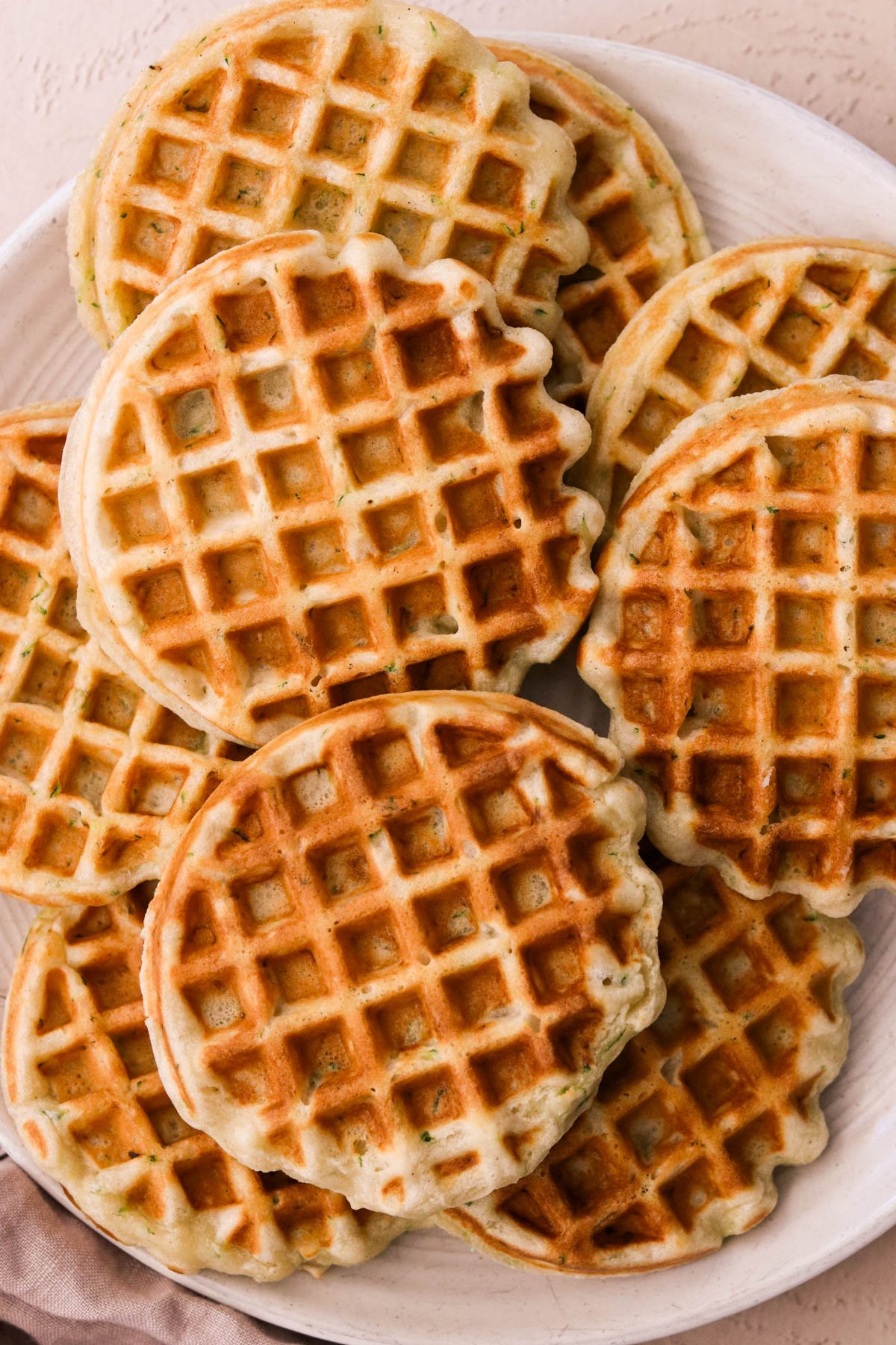 a close up shot of crispy ricotta waffles on a plate