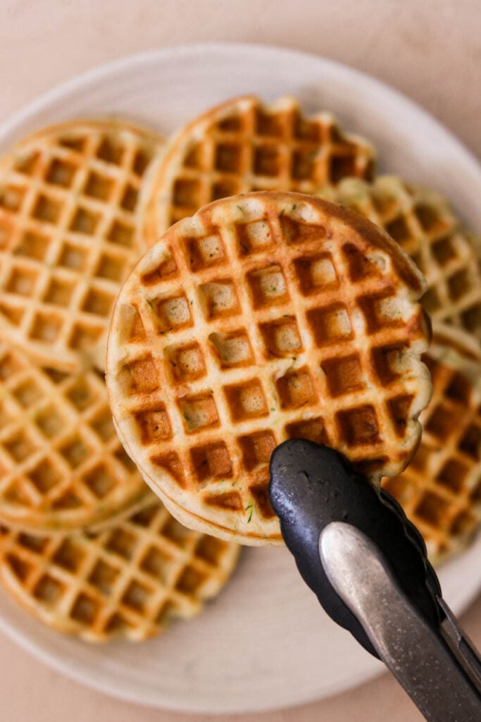 Freshly cooked ricotta waffles on a white plate