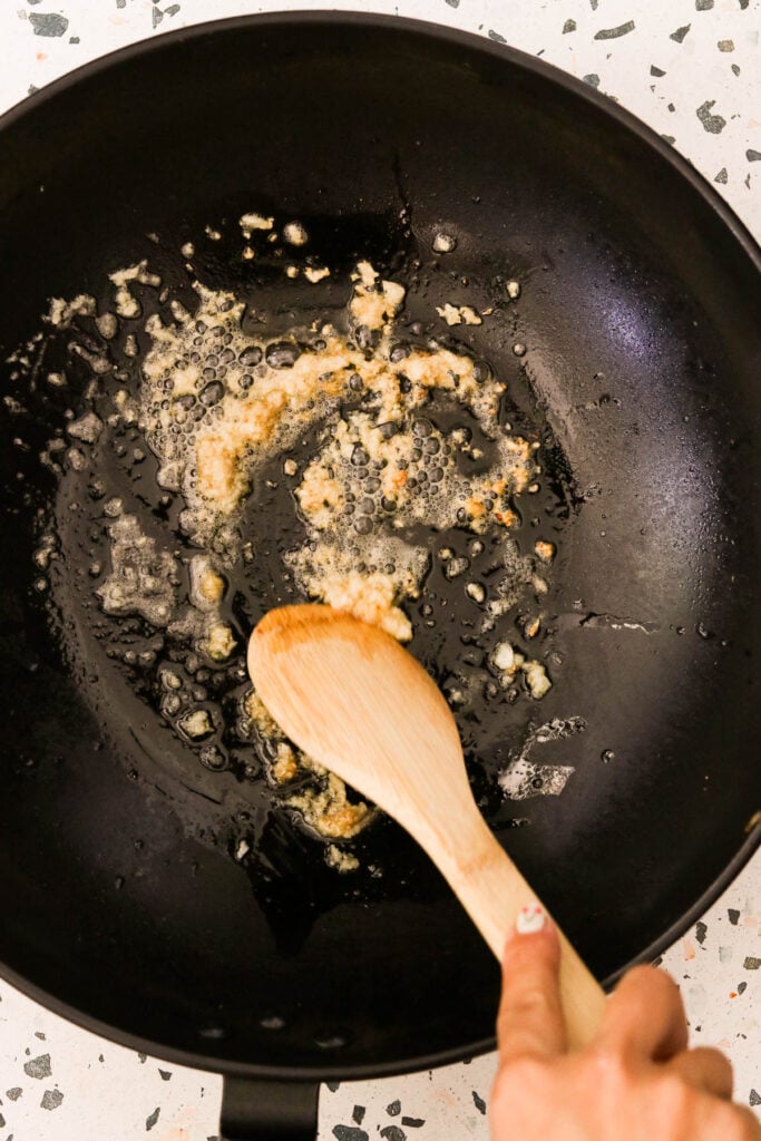 garlic sauteeing in a hot skillet