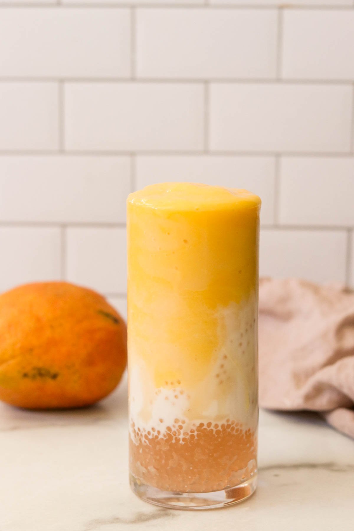 mango sticky rice smoothie in a glass with tapioca pearls
