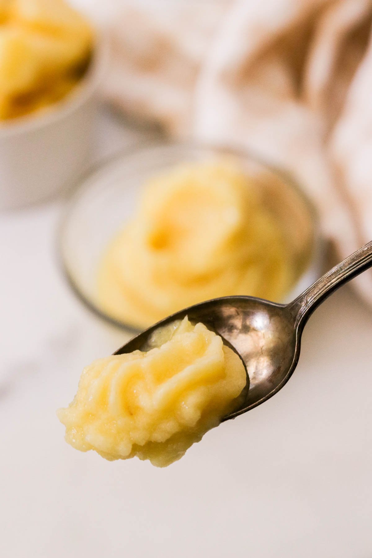 Frozen pineapple dessert scooped onto a spoon