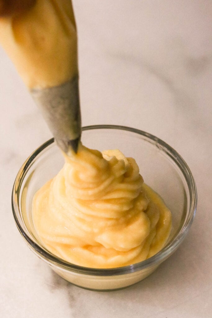 Pineapple Dole Whip piped into a swirl in a glass bowl