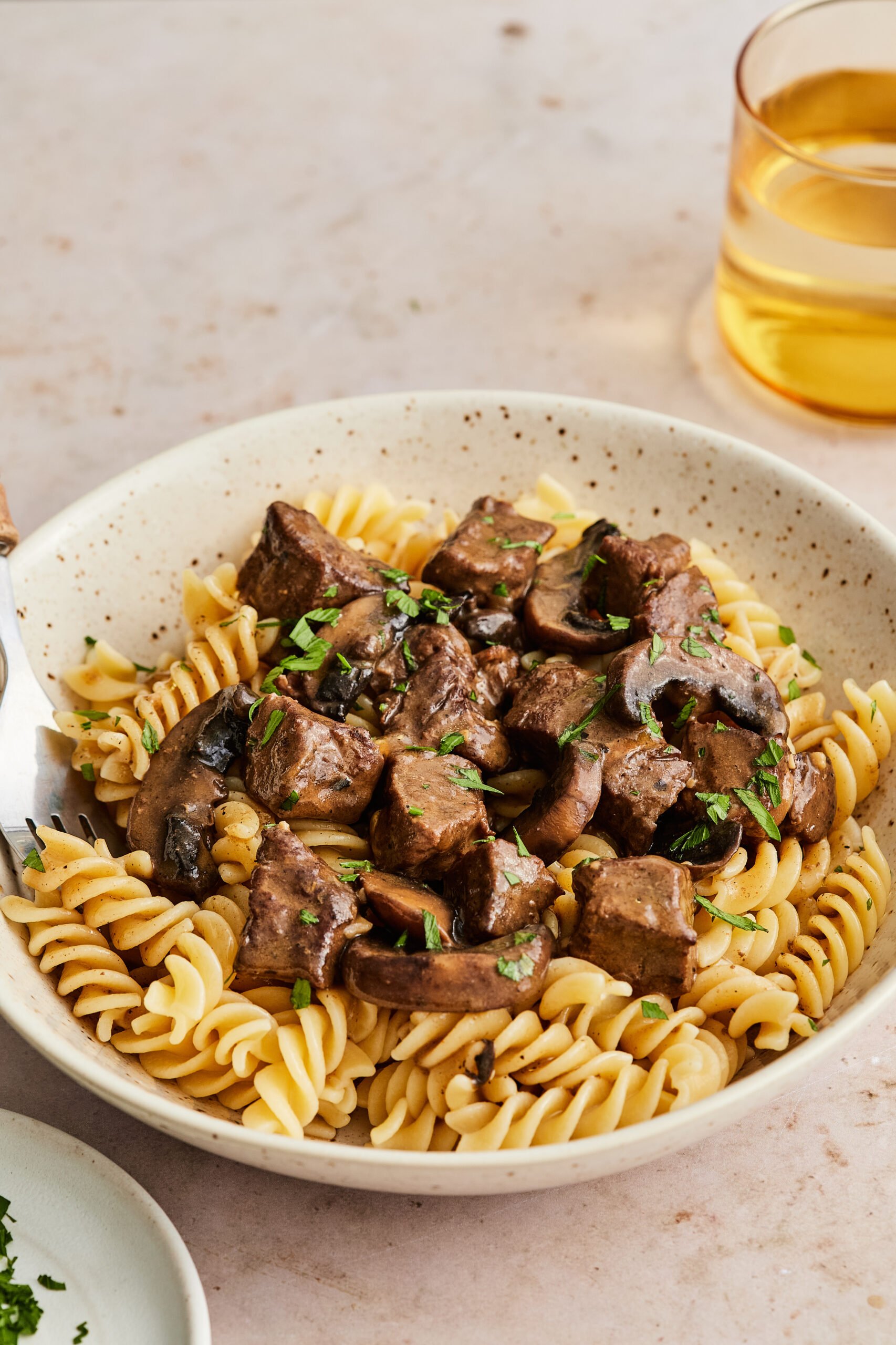 Plated dairy-free beef stroganoff alongside zucchini noodles, ready to serve.