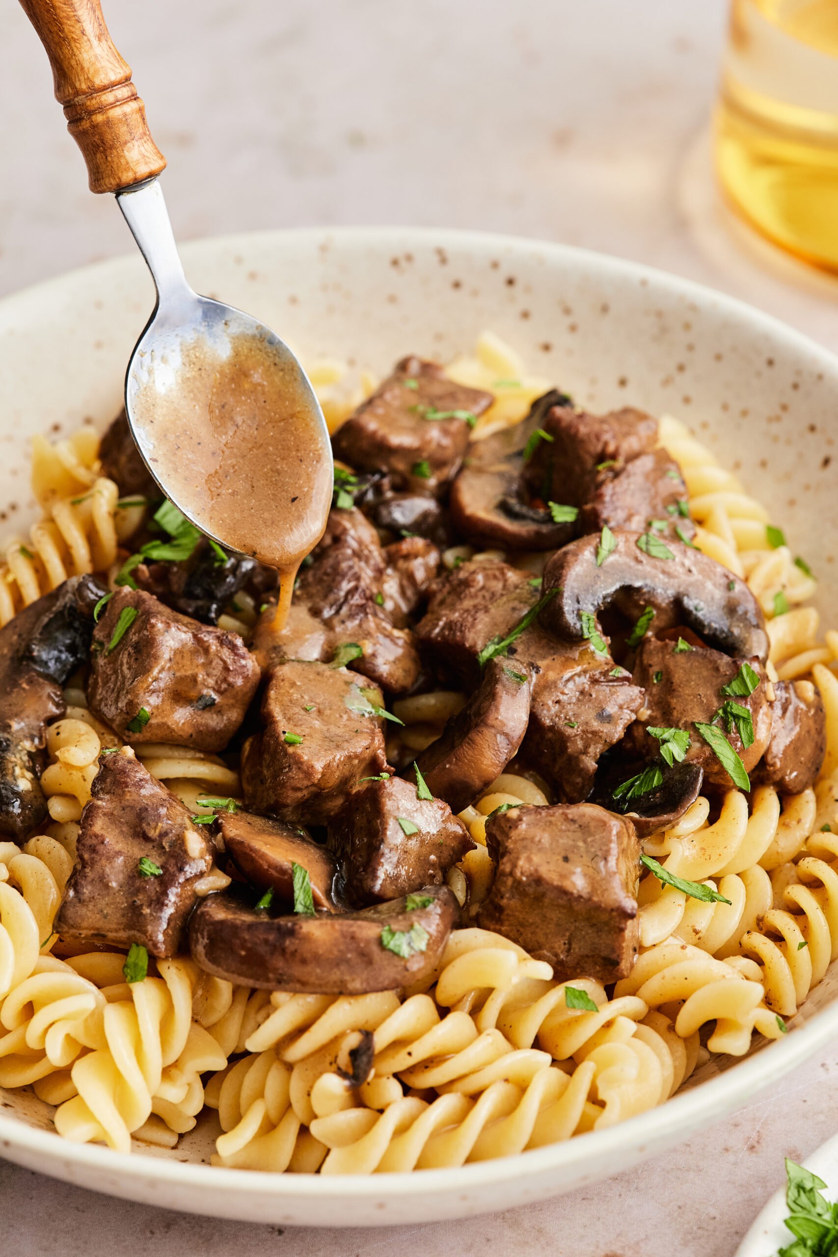 Close-up of creamy dairy-free stroganoff in the pan with beef and mushrooms coated in sauce.