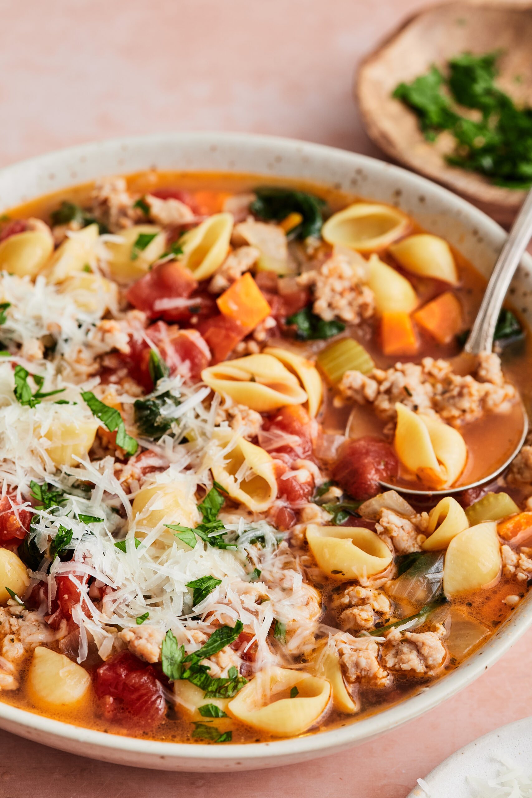 Italian sausage and pasta soup in a bowl with visible pasta shells, sausage, and vegetables in a tomato-based broth.