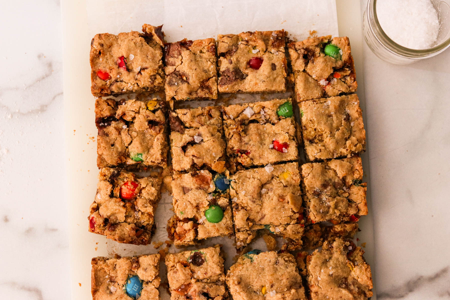 Leftover Halloween candy cookie bars sliced into squared, ready to eat.